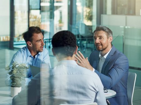 Office, planning and business men in meeting for marketing strategy, ideas and work project. Teamwork, collaboration and group of male workers in discussion for goals, target and vision in building
